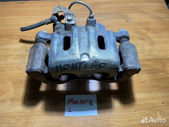 Суппорт тормозной передний левый mitsubishi pajero