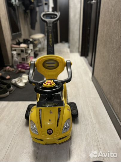 Детская машинка каталка с ручкой музыкальная