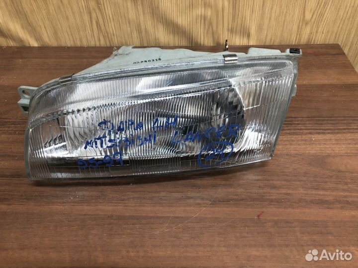 Фара левая Mitsubishi Lancer