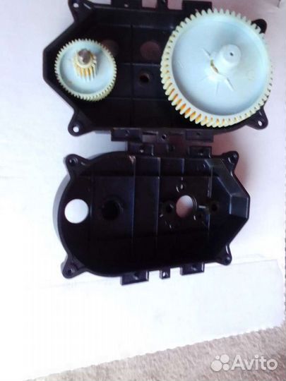 Корпус привода и две шестерёнки электромясорубки