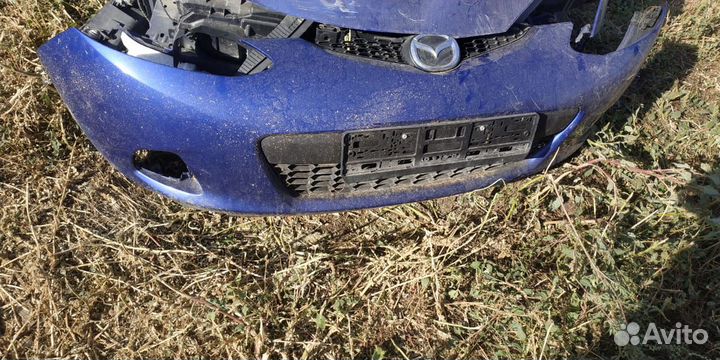Передний бампер Мазда Демио де
