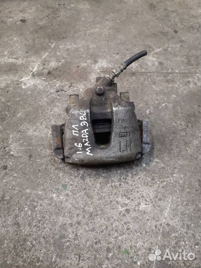 Суппорт тормозной передний левый Mazda 3 BL рест