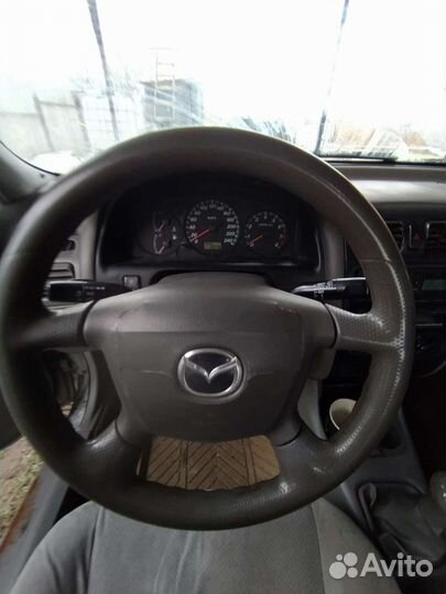 Дверь левая передняя мазда 626GF капелла