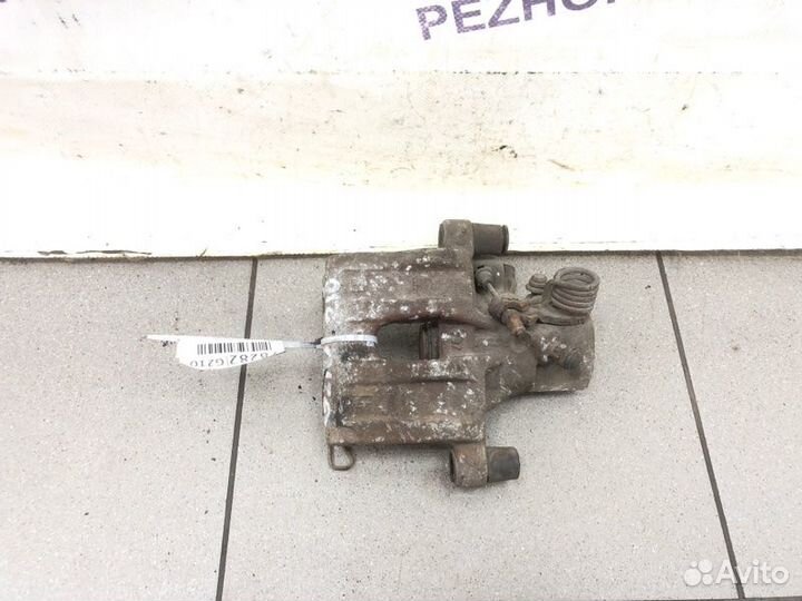 Суппорт тормозной задний левый Ford Focus хэтчбек