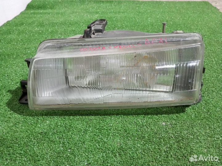 Фара галогеновая левая Toyota Corolla AE91