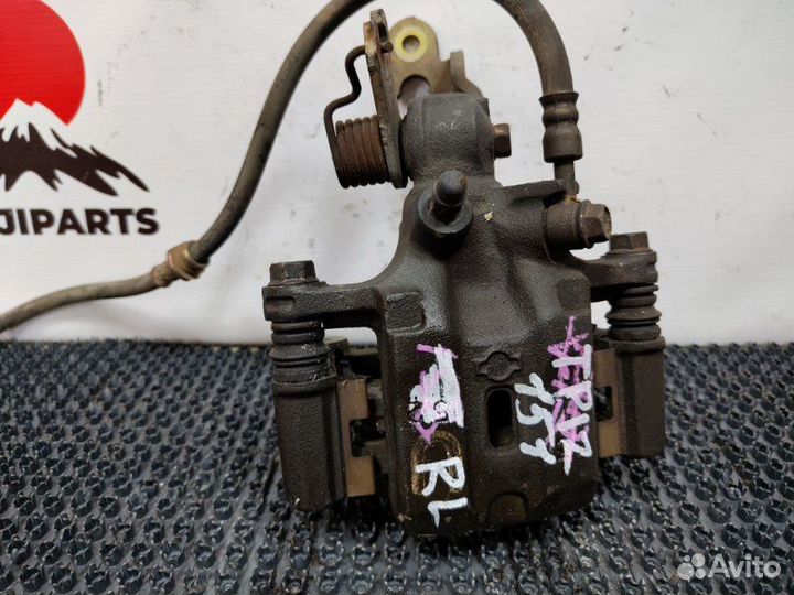 Суппорт тормозной задний левый Nissan Primera TP12