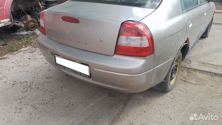 Бампер задний Kia Shuma 1