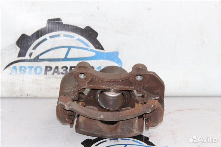 Суппорт тормозной передний левый Nissan Primera