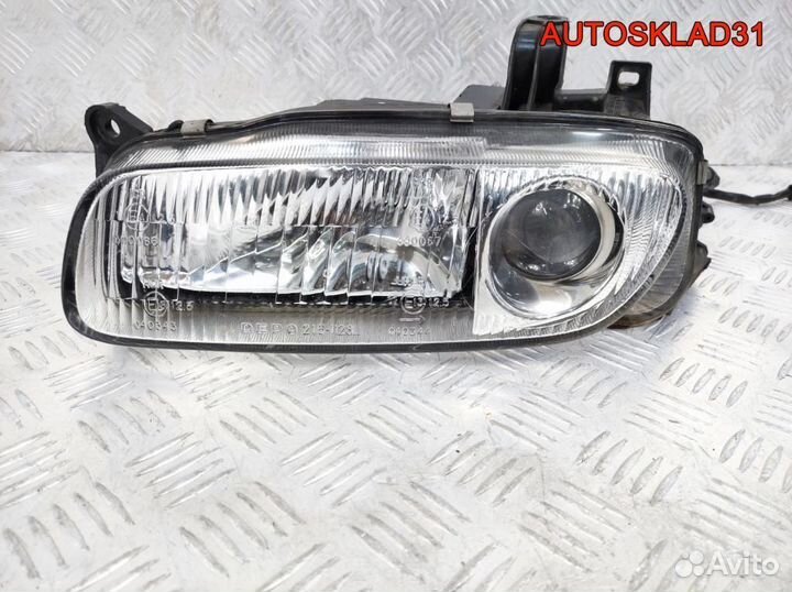 Фара левая Mazda 323 BA 2161128L