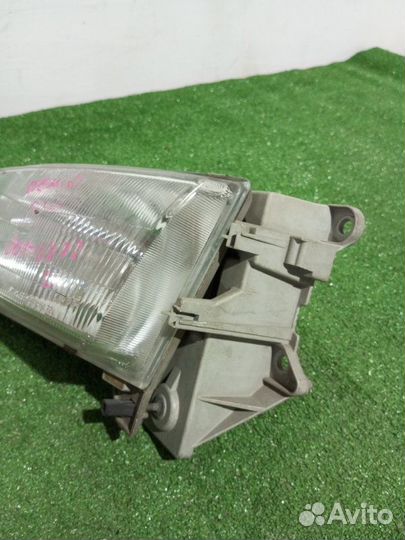 Фара галогеновая левая Mazda Demio