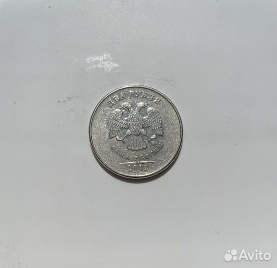 Монета с браком. Орел прочеканен поверх решки